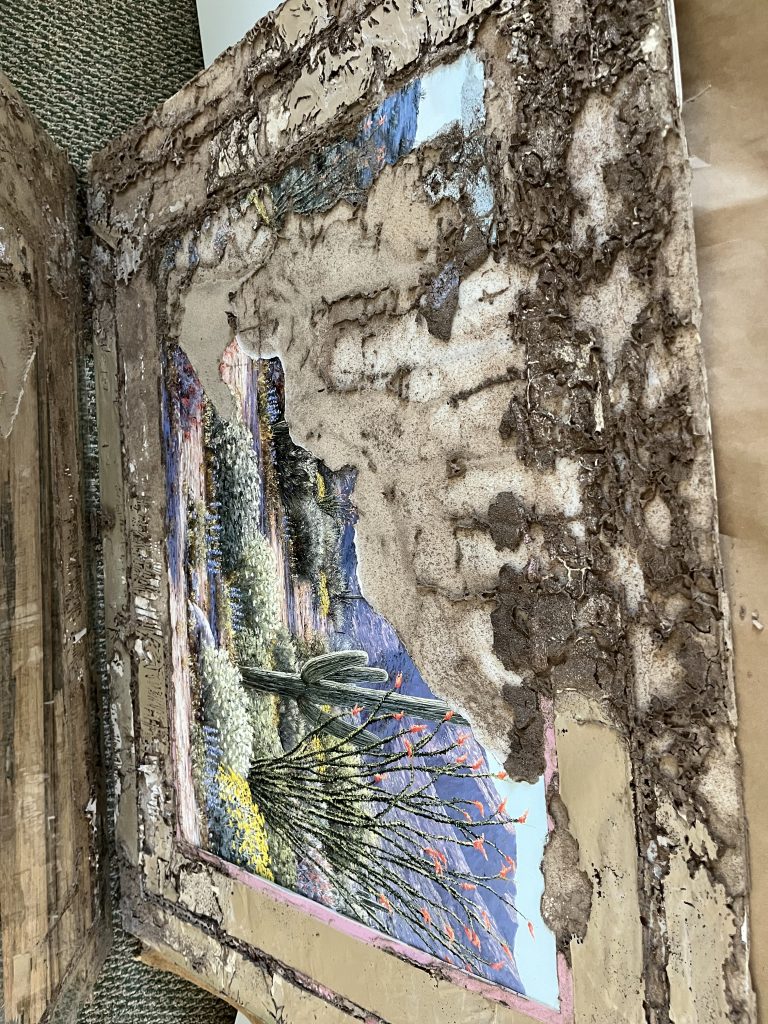 A large framed painting half-eaten by termites